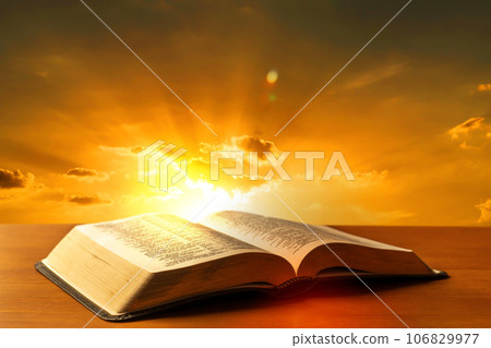 Holy Bible book on a wooden desk with sunset light background 106829977