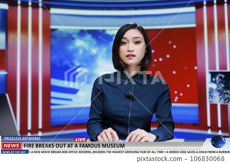 Anchorwoman talks about fire at museum on international news channel, famous artifacts and artworks in danger after building started burning. Journalist reports disaster at historical landmark. 106830068