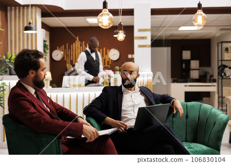 During international business conference, employees forge new relations to guarantee future collaborations. Businessmen sharing cultures, ideas, and possibilities on corporate global stage. 106830104