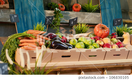 Colorful multiple fresh fruits and vegetables on counter, healthy eating organic products at local farmers market. Various seasonal locally grown produce sold at greenmarket, small business. Colorful multiple fresh fruits and vegetables on counter, healthy eating organic products at local farmers market. Various seasonal locally grown produce sold at greenmarket, small business. 106830105