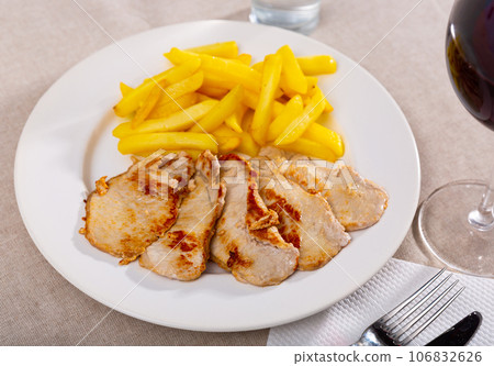 Roasted loin chops served with french fries Roasted loin chops served with french fries 106832626