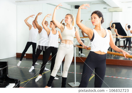 Sporty guys and girls performing beautiful dance elements Sporty guys and girls performing beautiful dance elements 106832723