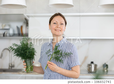Woman took out small sprig of dill weed fennel from large bunch of greenery Woman took out small sprig of dill weed fennel from large bunch of greenery 106832741