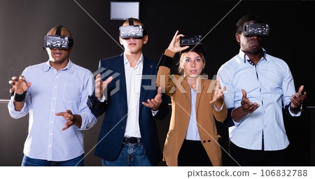 Multiethnic friends using virtual reality glasses Multiethnic friends using virtual reality glasses 106832788