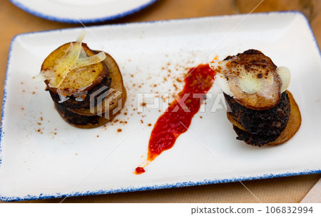 Spanish timbale of morcilla with caramelized pears and cheese Spanish timbale of morcilla with caramelized pears and cheese 106832994