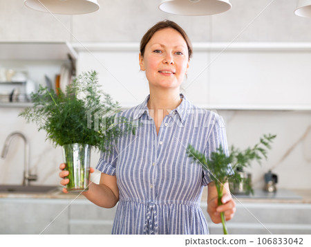 Woman took out small sprig of dill weed fennel from large bunch of greenery Woman took out small sprig of dill weed fennel from large bunch of greenery 106833042