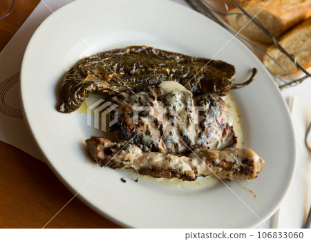 Iberian pork in roquefort sauce with baked pepper 106833060