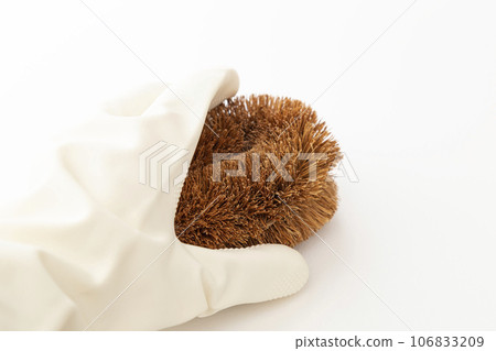 Hand holding scrubbing brush, white background 106833209