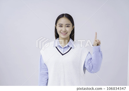 Portrait of a female student doing the number 1 pose against a white background Portrait of a female student doing the number 1 pose against a white background 106834347
