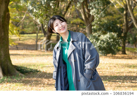 A woman enjoying a sunny autumn park A woman enjoying a sunny autumn park 106836194