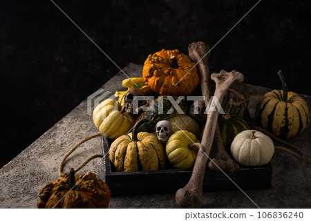 Halloween still life with pumpkin and bones Halloween still life with pumpkin and bones 106836240