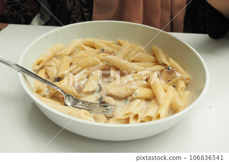 plate of cream and herb pasta on table plate of cream and herb pasta on table 106836541