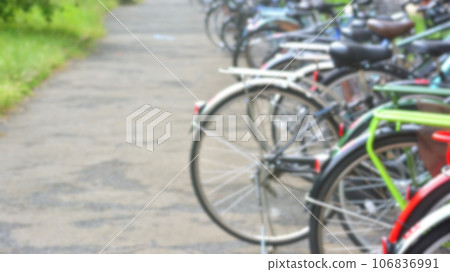 Many bicycles lined up at a bicycle storage area, blurred Many bicycles lined up at a bicycle storage area, blurred 106836991