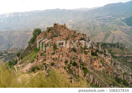 Dagestan Gamsutl. Ancient ghost town of Gamsutl old stone houses in abandoned Gamsutl mountain village in Dagestan, Abandoned etnic aul, summer landscape. Dagestan Gamsutl. Ancient ghost town of Gamsutl old stone houses in abandoned Gamsutl mountain village in Dagestan, Abandoned etnic aul, summer landscape. 106837834