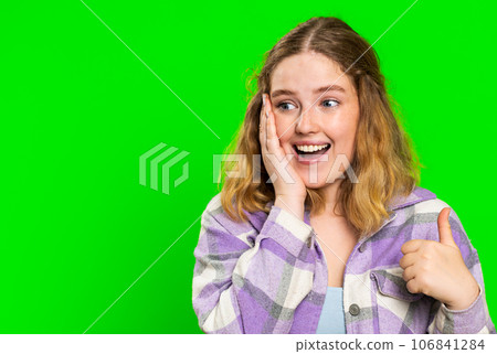 Young woman raises thumbs up agrees or gives positive reply recommends advertisement likes good idea 106841284