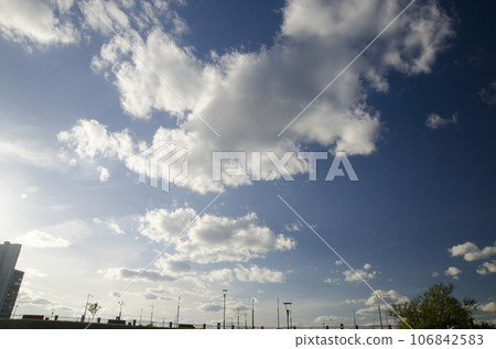Deep blue summer sky over city houses Deep blue summer sky over city houses 106842583