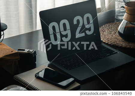 Home computer desk and digital clock on screen 106843540