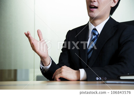 Body parts of a young male businessman having a meeting while looking at documents in the office Body parts of a young male businessman having a meeting while looking at documents in the office 106843576