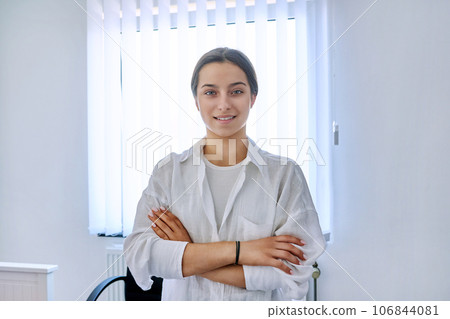 Portrait of smiling teen girl at home near window Portrait of smiling teen girl at home near window 106844081