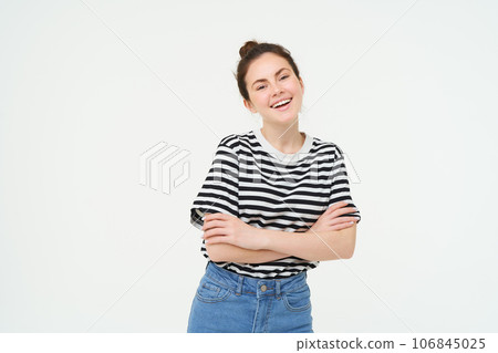 Image of charismatic young woman in striped t-shirt and jeans, looking confident and happy, smiling at camera, candid emotions, white background 106845025