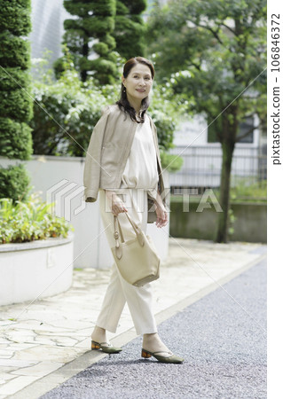 Outdoor senior woman fashion portrait vertical position 106846372