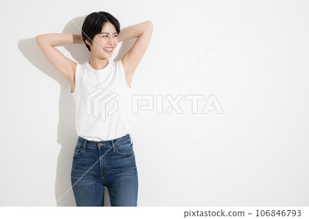 A woman wearing a T-shirt with her arms raised 106846793