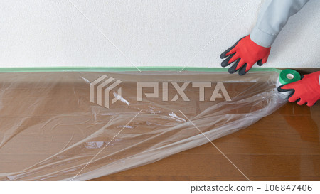 Workers curing the floor with curing materials and maskers Workers curing the floor with curing materials and maskers 106847406