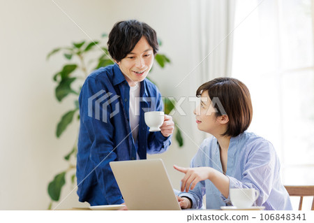 couple looking at computer together couple looking at computer together 106848341