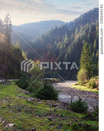 nature landscape with trees on the bank of a river in autumn. scenery in evening light 106849145