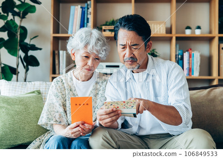 A senior couple thinking about retirement money in the living room 106849533