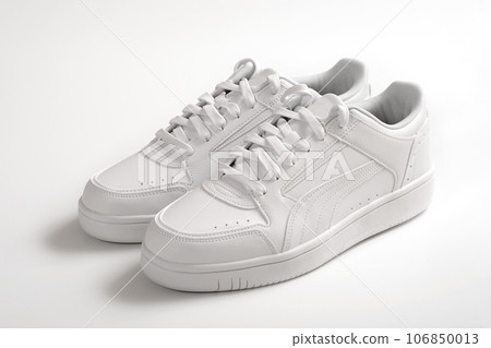 Close-up of white sports shoes on a white background. Close-up of white sports shoes on a white background. 106850013