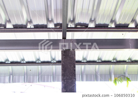 Under galvanized roof have nut structure to fix concrete column to large steel bar beam. Construction of rural houses in Thailand. Tightening with screws with washer Simple construction design, strong 106850310