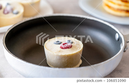 Frozen batter for pancakes are homemade preparation or trendy ice cube pancakes. Frozen batter cube in the fry pan 106851090
