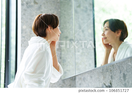 A woman in her 40s in a bathrobe A woman in her 40s in a bathrobe 106851727