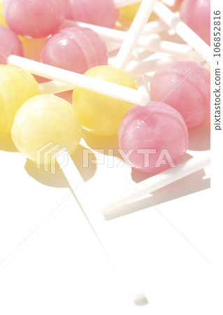 A photo of a spherical candy attached to a stick against a white background A photo of a spherical candy attached to a stick against a white background 106852816