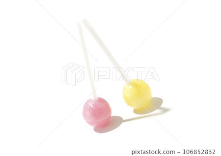 A photo of a spherical candy attached to a stick against a white background A photo of a spherical candy attached to a stick against a white background 106852832