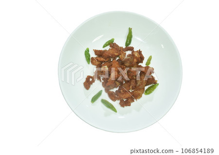 fried fermenting pork bone with garlic and chili on plate fried fermenting pork bone with garlic and chili on plate 106854189