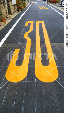 A scene where a speed limit of 30km/h is displayed on the road surface A scene where a speed limit of 30km/h is displayed on the road surface 106855346