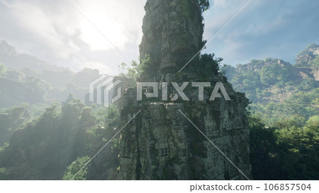 A majestic rock formation standing tall in the heart of a lush forest in China A majestic rock formation standing tall in the heart of a lush forest in China 106857504