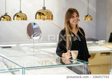 Mature middle age beautiful female business owner in a jewelry shop, portrait. 106857702