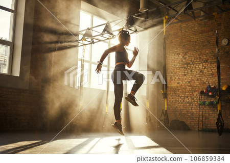 Always in good shape Full length of athletic woman in black sport clothing exercising in professional gym. 106859384