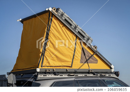 open tent on a roof of SUV, car camping concept 106859635