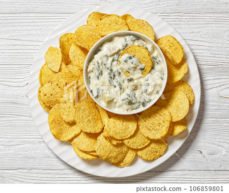 artichoke spinach almond dip with potato chips artichoke spinach almond dip with potato chips 106859801