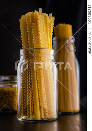 Mafaldine pasta. Uncooked italian pasta in jar. 106860811