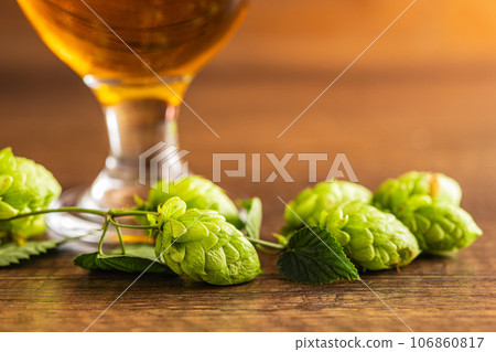 Green hops crop on wooden table. Green hops crop on wooden table. 106860817
