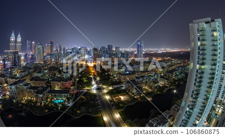 Panorama with skyscrapers in Barsha Heights district and low rise buildings in Greens district aerial day to night timelapse. 106860875