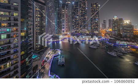 Panorama showing luxury yacht bay in the city aerial night timelapse in Dubai marina 106860892