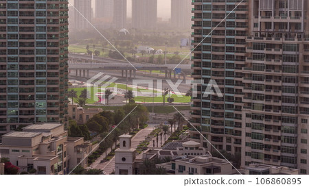Aerial sunrise view of towers in greens district area timelapse from Dubai marina. 106860895