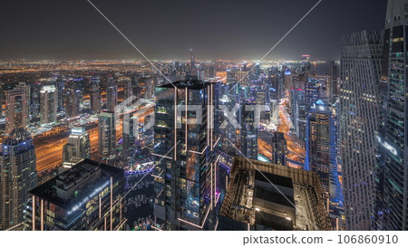 Panorama showing JBR district and Dubai Marina with JLT. Traffic between skyscrapers aerial night timelapse. 106860910