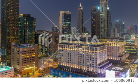 Dubai International Financial district aerial day to night timelapse. Panoramic view of business and financial office towers. Dubai International Financial district aerial day to night timelapse. Panoramic view of business and financial office towers. 106860915